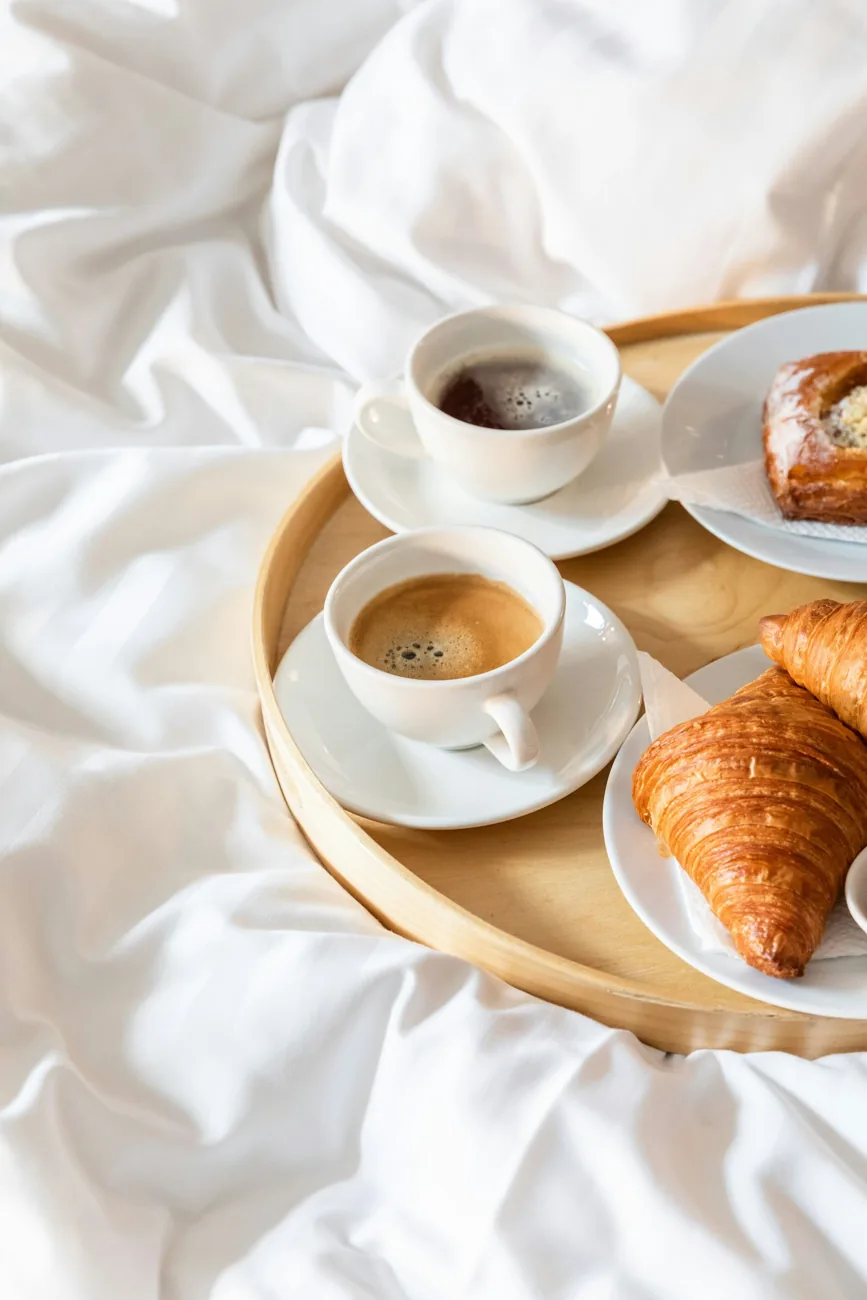 Illustrative breakfast tray with coffee and pastry